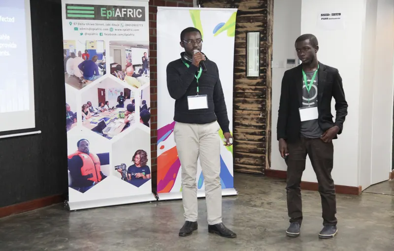 Hackathon teams presenting and discussing their solutions in a shared workspace
